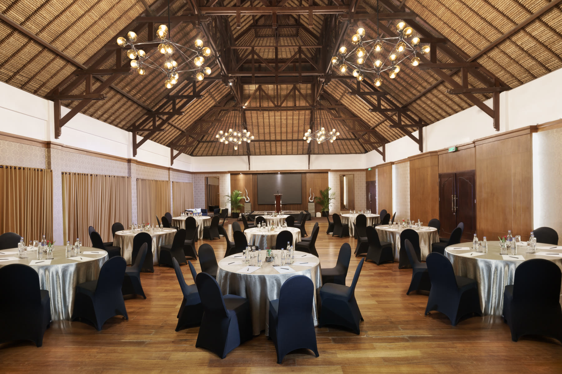 The event hall beneath its timber roof, set for a banquet